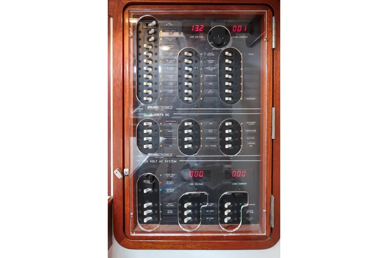 Slide: The Image of Electrical panel of a 1992 Morris Ocean Series 44 yacht, featuring voltage and load current displays. - 50
