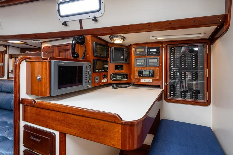 Slide: The Image of Navigation station of 1992 Morris Ocean Series 44 yacht with control panels and equipment. - 28