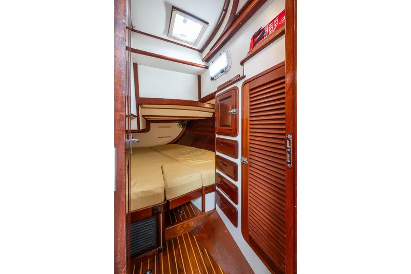 Slide: The Image of Interior cabin of 1992 Morris Ocean Series 44 yacht with wooden finishes and cozy bed. - 44