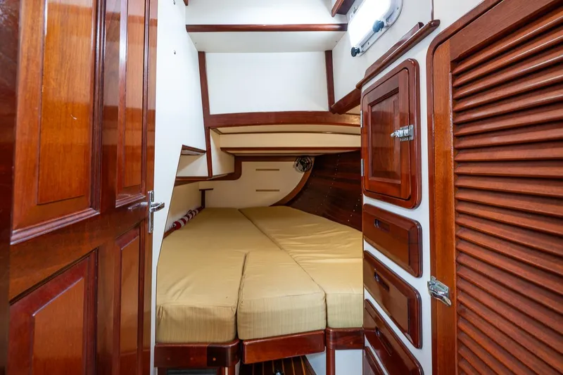 Slide: The Image of Interior cabin of 1992 Morris Ocean Series 44 yacht with wooden finishes and cozy bedding. - 42