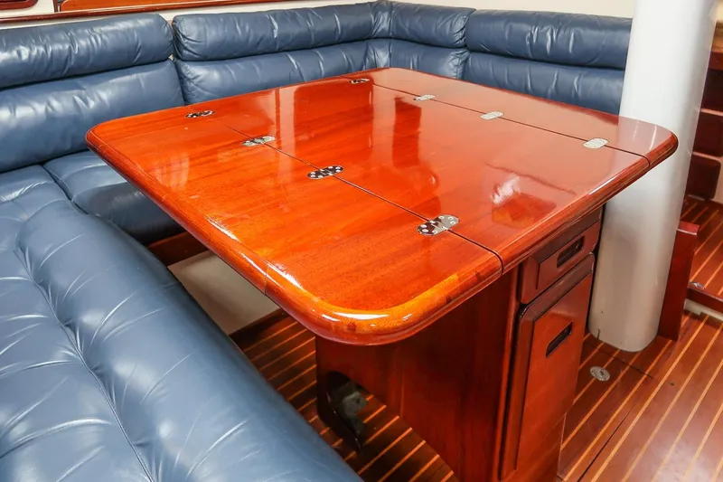 Slide: The Image of Luxurious wooden table and blue seating in 1992 Morris Ocean Series 44 yacht interior. - 33