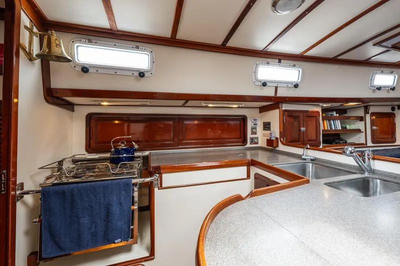 Slide: The Image of Interior of 1992 Morris Ocean Series 44 yacht kitchen with wood accents and modern amenities. - 26