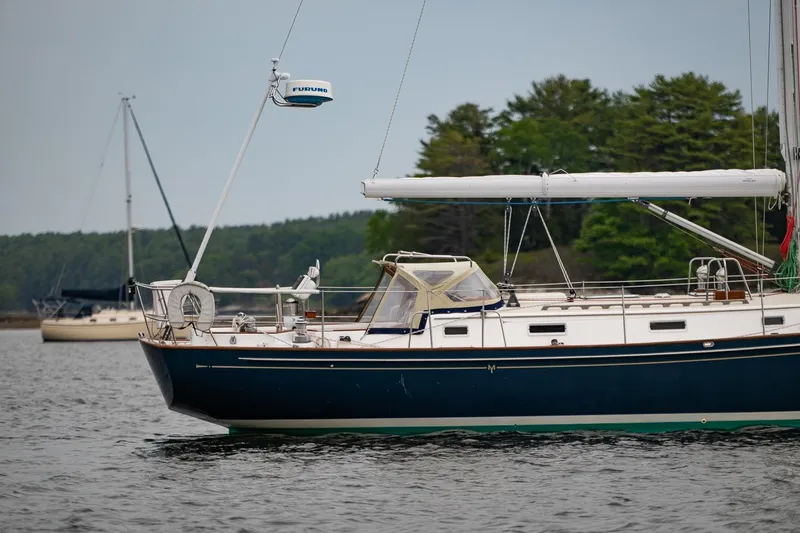Slide: The Image of Sailboat Morris Ocean Series 44, 1992 model, anchored on calm water with trees in background. - 63