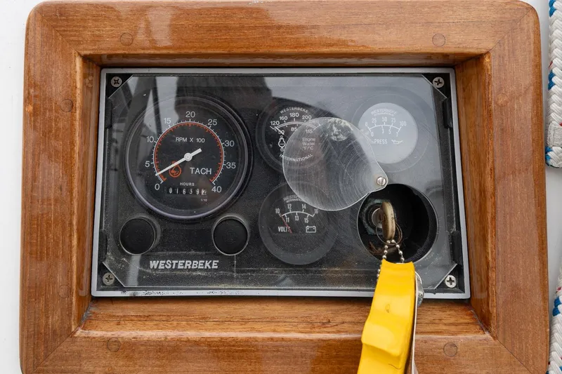 Slide: The Image of Control panel of a 1992 Morris Ocean Series 44 sailboat with tachometer and key. - 54