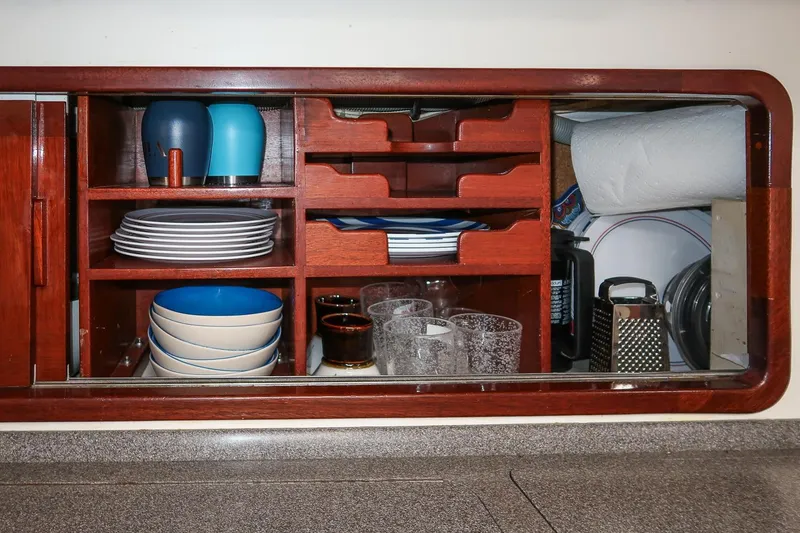 Slide: The Image of Cabinet interior with dishes and kitchenware on Morris Ocean Series 44 yacht, 1992 model. - 27