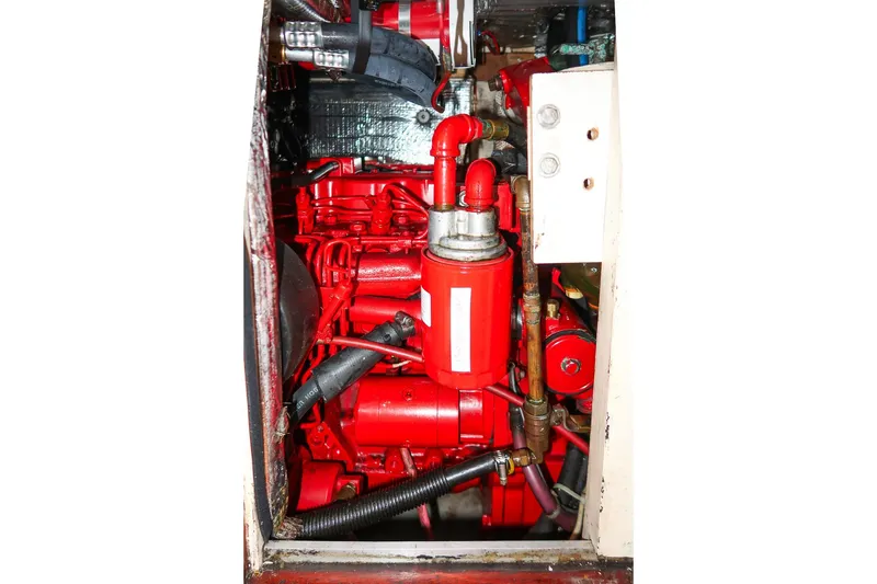 Slide: The Image of Engine compartment of a 1992 Morris Ocean Series 44, featuring a vibrant red engine. - 53