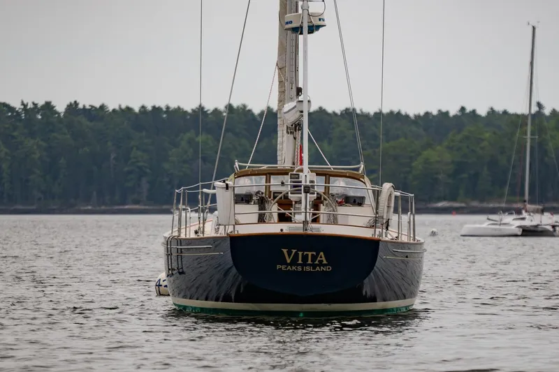 Slide: The Image of Sailboat "Vita" on water, Morris Ocean Series 44, 1992, with forested shoreline background. - 66