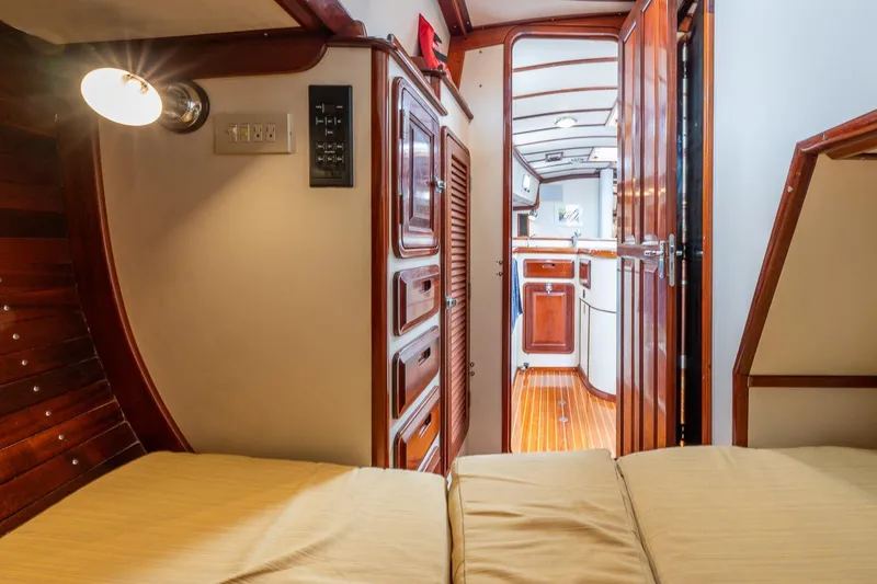 Slide: The Image of Interior of 1992 Morris Ocean Series 44 yacht, featuring wooden cabinetry and cozy sleeping area. - 45