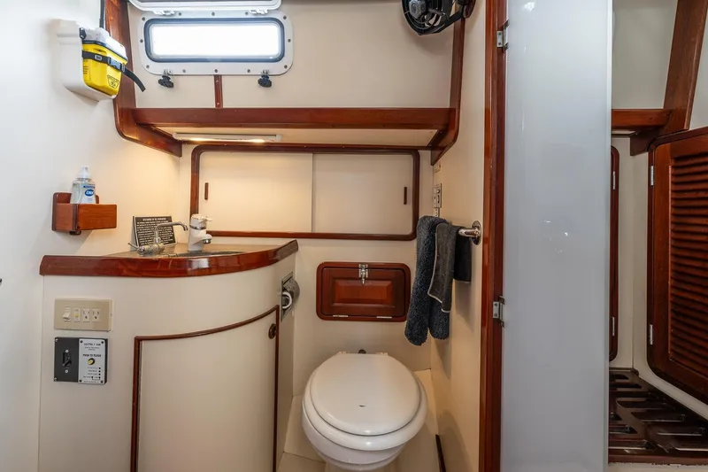 Slide: The Image of Bathroom interior of 1992 Morris Ocean Series 44 yacht, featuring wood accents and compact design. - 46
