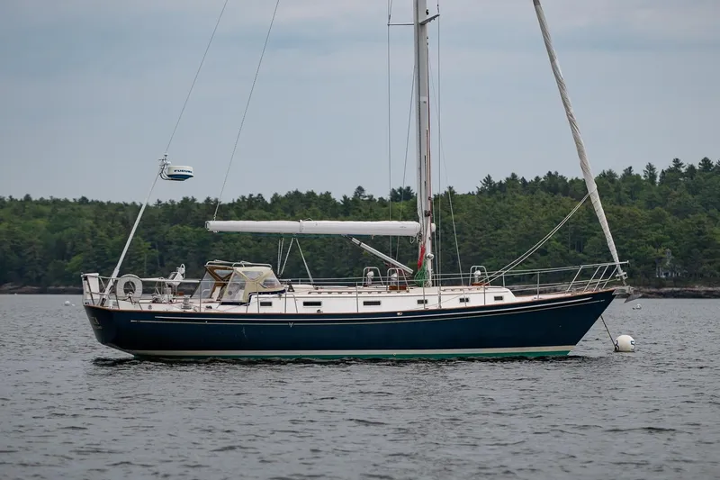 Slide: The Image of Sailboat Morris Ocean Series 44, 1992 model, anchored on calm water with forested background. - 5