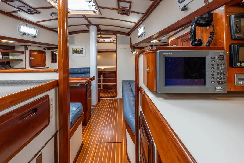 Slide: The Image of Interior of 1992 Morris Ocean Series 44 yacht, featuring wood finishes and navigation equipment. - 30