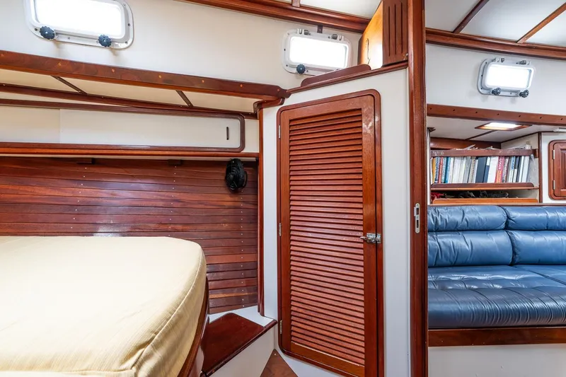 Slide: The Image of Interior of 1992 Morris Ocean Series 44 yacht with wood paneling and blue seating. - 37
