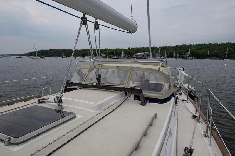 Slide: The Image of 1992 Morris Ocean Series 44 sailboat on calm waters, featuring a spacious deck and clear canopy. - 13