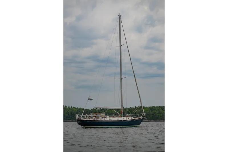 Slide: The Image of Sailboat on calm water, Morris Ocean Series 44, 1992 model, under cloudy sky. - 65