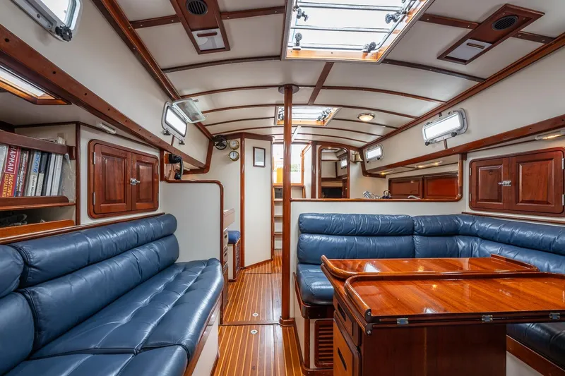 Slide: The Image of Luxurious interior of 1992 Morris Ocean Series 44 yacht with blue leather seating and wooden finishes. - 39