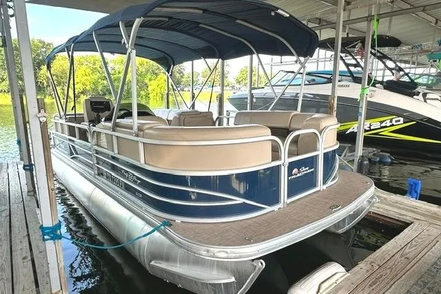 The Image of 2019 Sun Tracker Party Barge 22 XP3 pontoon boat docked under a canopy. - 0