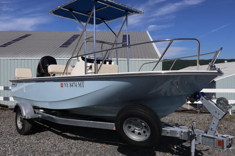The Image of 2023 Boston Whaler 170 Montauk boat on trailer, parked outdoors under blue sky. - 1