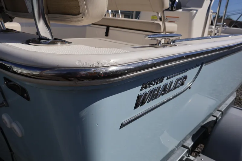 Slide: The Image of 2023 Boston Whaler 170 Montauk boat, close-up of logo and seating area. - 14