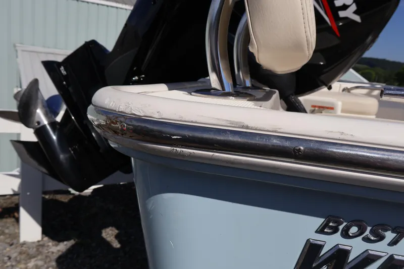 Slide: The Image of 2023 Boston Whaler 170 Montauk boat with visible hull scratches and Mercury outboard motor. - 15
