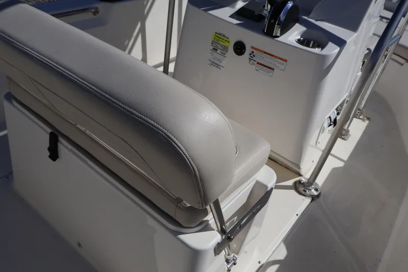 Slide: The Image of 2023 Boston Whaler 170 Montauk boat interior with cushioned seating and control panel. - 21