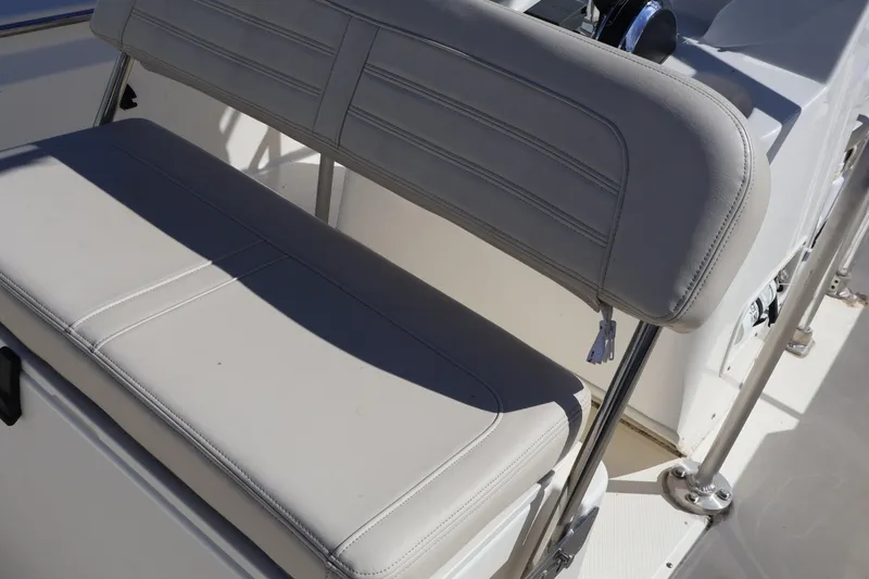 Slide: The Image of 2023 Boston Whaler 170 Montauk boat seat with white cushioned upholstery. - 23