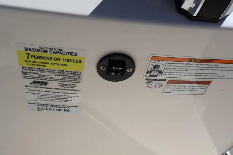 Slide: The Image of 2023 Boston Whaler 170 Montauk capacity and safety warning labels on boat interior. - 26