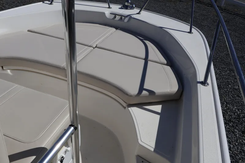Slide: The Image of 2023 Boston Whaler 170 Montauk boat interior with cushioned seating and stainless steel railing. - 29