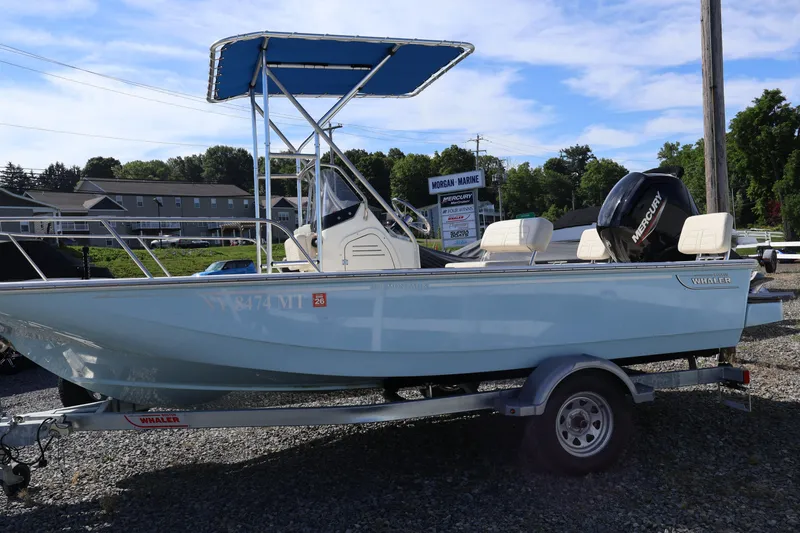 Slide: The Image of 2023 Boston Whaler 170 Montauk boat on trailer, featuring a Mercury engine, parked outdoors. - 3
