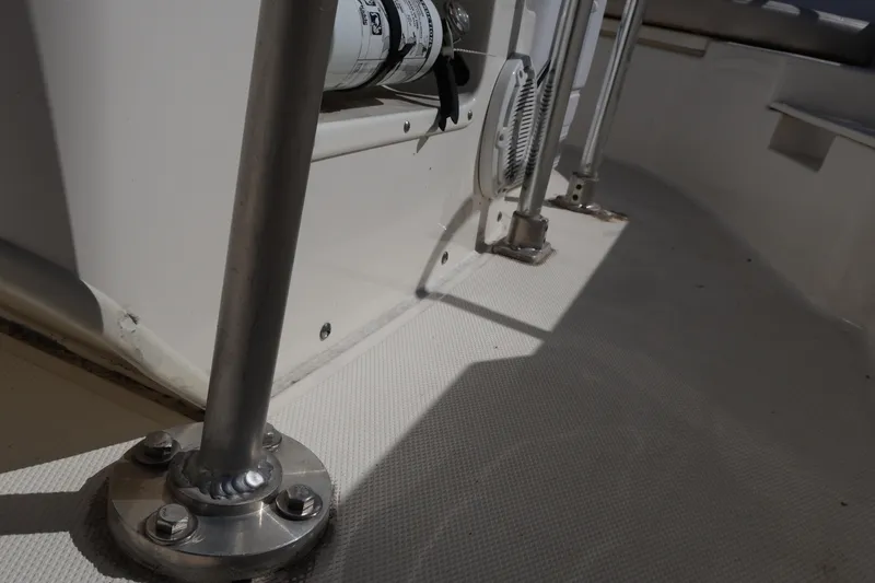 Slide: The Image of Close-up of 2023 Boston Whaler 170 Montauk boat interior, showcasing metal fixtures and textured flooring. - 38