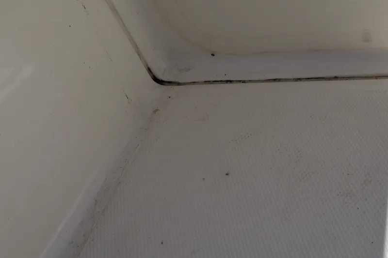 Slide: The Image of Interior corner of a 2023 Boston Whaler 170 Montauk boat, showing textured flooring. - 39