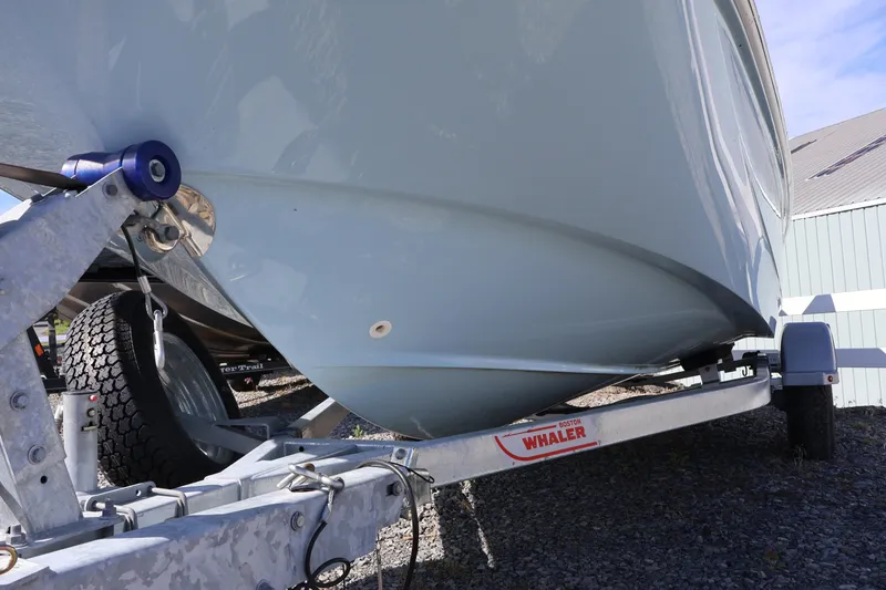 Slide: The Image of 2023 Boston Whaler 170 Montauk on trailer, showcasing hull design and trailer details. - 6