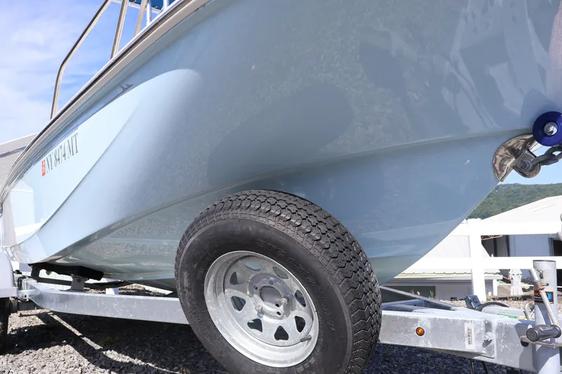 Slide: The Image of 2023 Boston Whaler 170 Montauk boat on trailer, side view with clear sky background. - 7