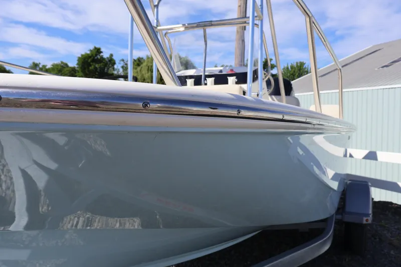 Slide: The Image of 2023 Boston Whaler 170 Montauk boat, close-up view, showcasing sleek design and stainless steel railing. - 8