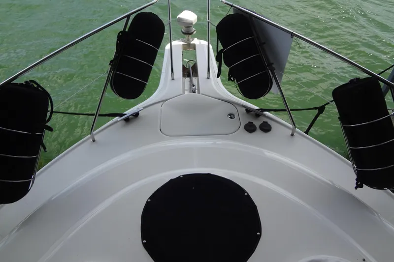 Slide: The Image of Bow view of 2005 Silverton 34 Convertible yacht on green water. - 11