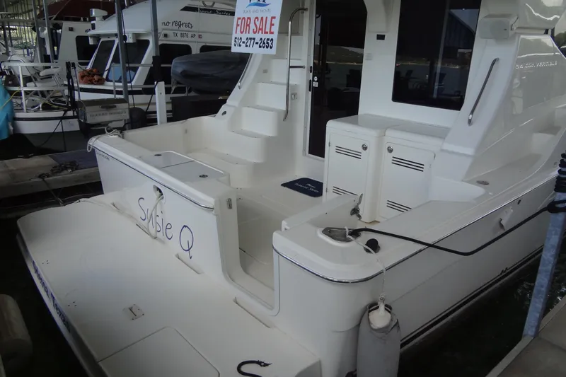 Slide: The Image of 2005 Silverton 34 Convertible yacht for sale, docked with visible "For Sale" sign. - 14
