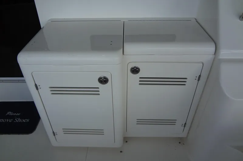 Slide: The Image of White storage cabinets on a 2005 Silverton 34 Convertible boat deck. - 16