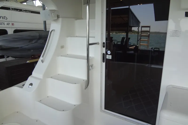 Slide: The Image of 2005 Silverton 34 Convertible yacht interior with stairs and glass door, docked by the water. - 18