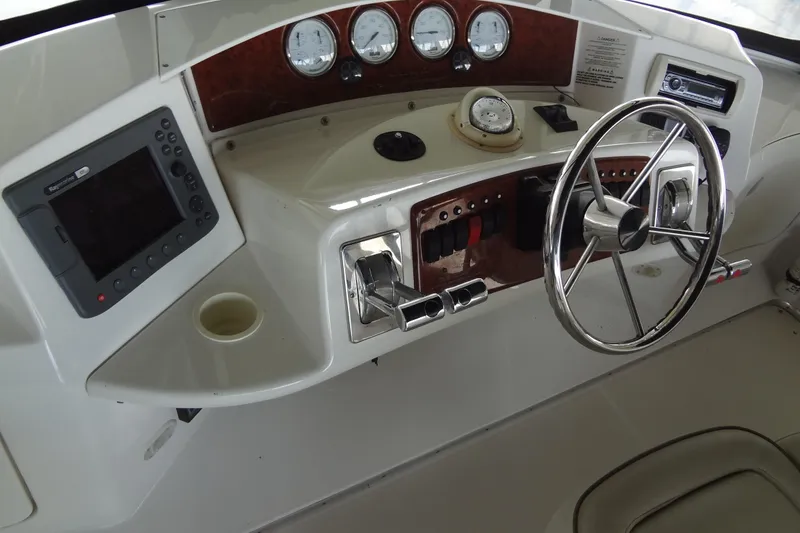 Slide: The Image of Control panel of a 2005 Silverton 34 Convertible boat with steering wheel and gauges. - 20