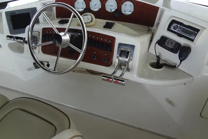 Slide: The Image of 2005 Silverton 34 Convertible helm with steering wheel, gauges, and control panel. - 22