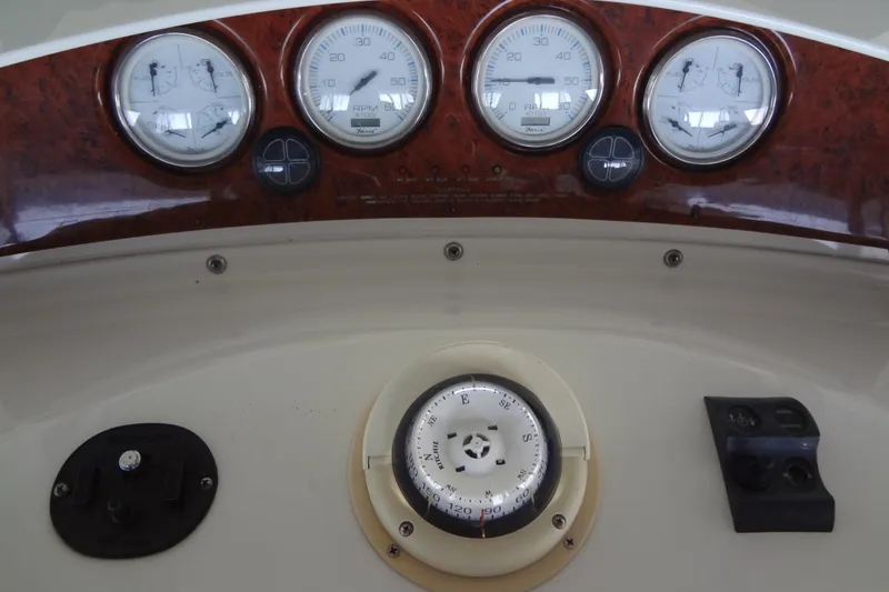 Slide: The Image of Dashboard of a 2005 Silverton 34 Convertible boat with gauges and compass. - 23