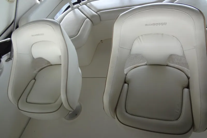 Slide: The Image of 2005 Silverton 34 Convertible boat interior with white cushioned seats. - 28
