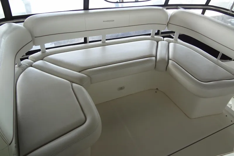 Slide: The Image of 2005 Silverton 34 Convertible yacht interior with white cushioned seating. - 31