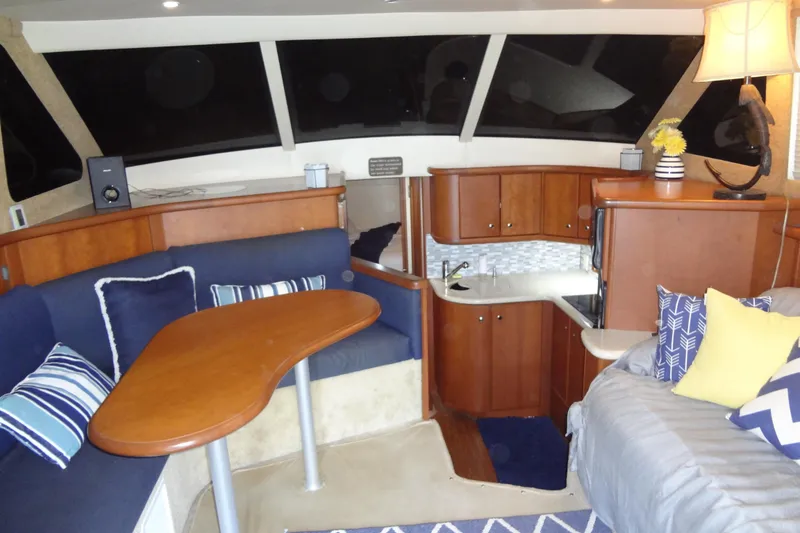 Slide: The Image of Interior of 2005 Silverton 34 Convertible yacht with cozy seating and modern kitchenette. - 33