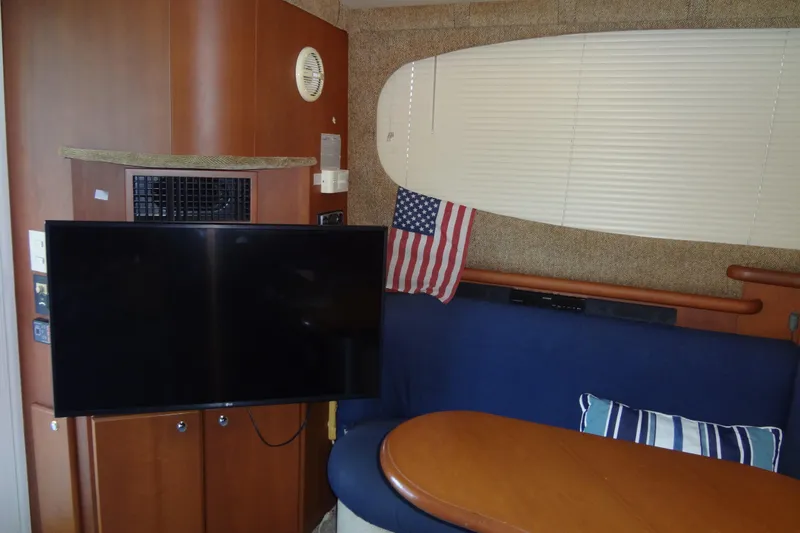 Slide: The Image of Interior of 2005 Silverton 34 Convertible yacht with TV, American flag, and seating area. - 35