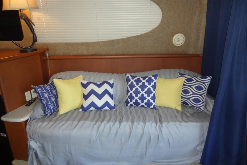 Slide: The Image of Interior of 2005 Silverton 34 Convertible with decorative pillows on a sofa. - 36