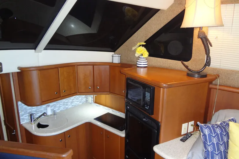 Slide: The Image of Interior of 2005 Silverton 34 Convertible yacht with modern kitchen and cozy decor. - 38