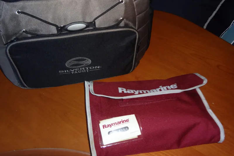 Slide: The Image of Bag and pouch on table, featuring Silverton Yacht and Raymarine branding. - 39