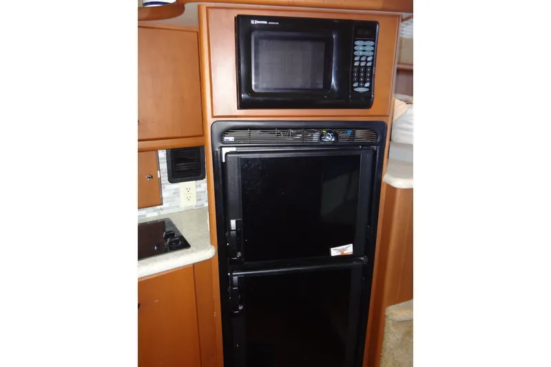Slide: The Image of Microwave and fridge in 2005 Silverton 34 Convertible yacht kitchen. - 41