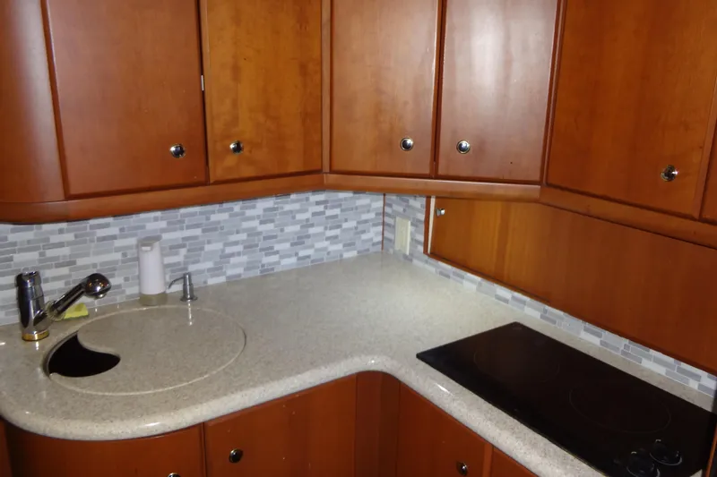 Slide: The Image of Luxurious 2005 Silverton 34 Convertible yacht kitchen with wood cabinets and modern appliances. - 42