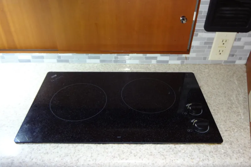 Slide: The Image of Electric stovetop on a 2005 Silverton 34 Convertible yacht kitchen counter. - 43